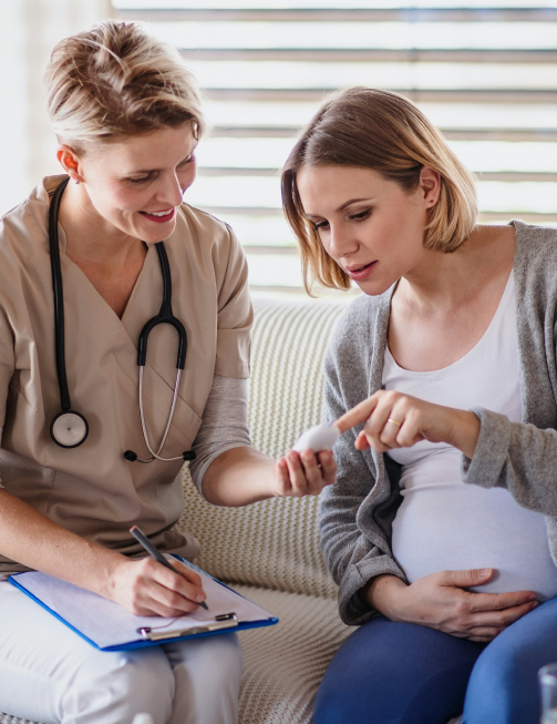 Diabetes educator reviewing a glucose log with a pregnant patient