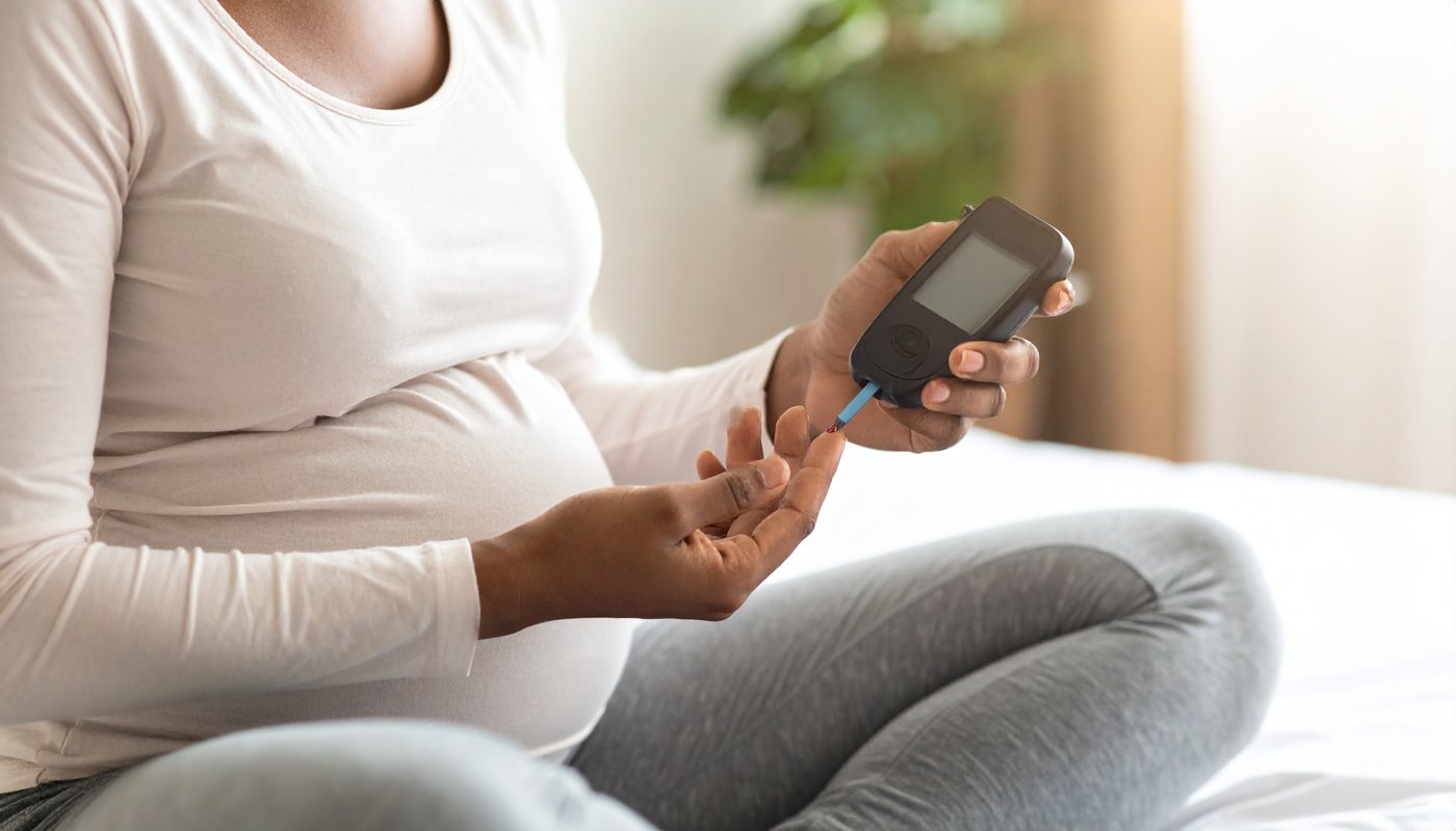 Expecting mom checking her blood sugar with a glucometer